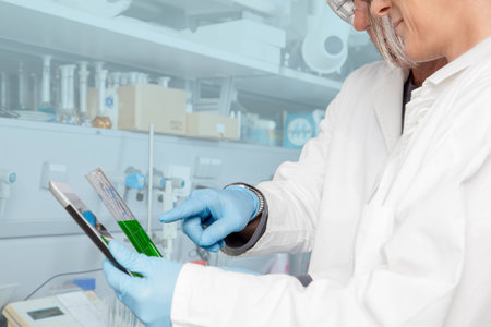 A Professor is teaching a chemist student in his Laboratory の写真素材