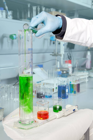 A Doctor is filling a large beaker with some alga liquid の写真素材