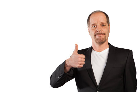 A well dressed Businessman shows a single thumb up sign on a white background の写真素材