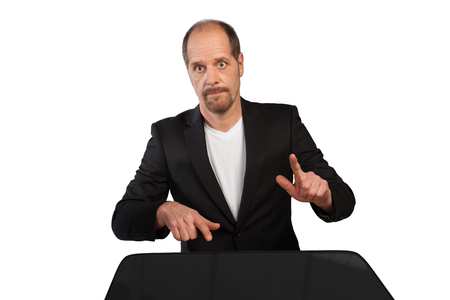 A Businessman is playing on a table with his fingers on a white background の写真素材