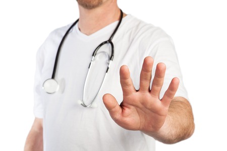 A Doctor use a stop gesture to prevent visitors to enter の写真素材