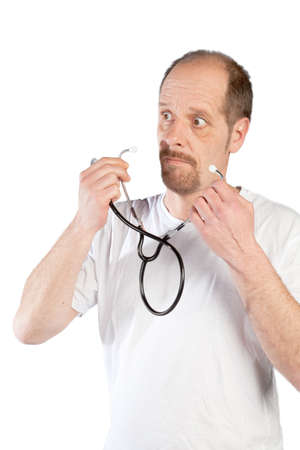 A doctor is using his stethoscope to do a health check の写真素材