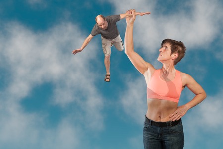 A man is flying with the help of an attractive woman in his dream 