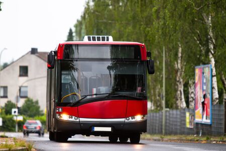 A german bus in motion on a street.の写真素材