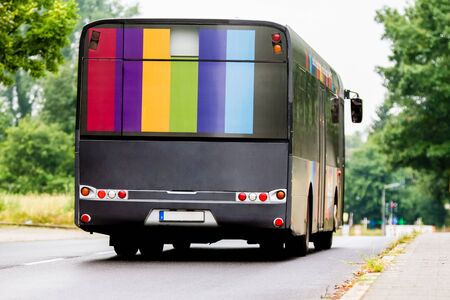 A german bus is driving on the road.の写真素材