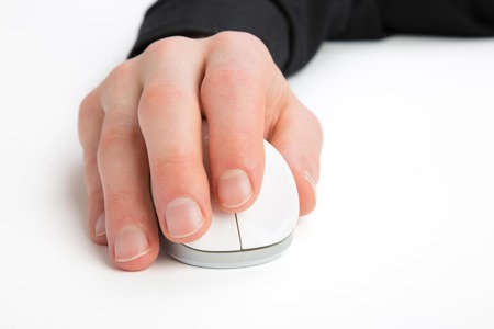 A Businessman is using a Computer Mouse on a white ground.の写真素材