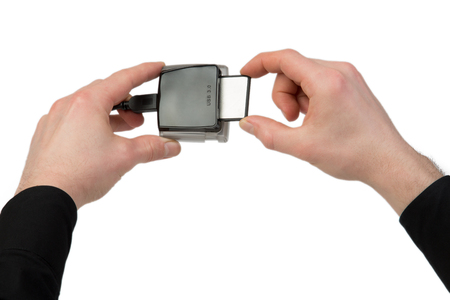 A man plugs in a Compact Flash Card into the card reader.