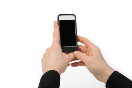 The Businessman is holding a mobile phone with two hands, isolated on white.の写真素材