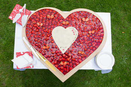 A Strawberry wedding cake in heart form.の写真素材