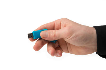 A man is holding a blue USB Stick in his right hand.の写真素材