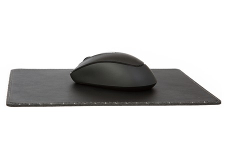 A Black Mouse on a Mouse Pad, isolated on a white background.の写真素材