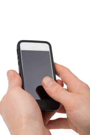 A Businessman is holding a phone in his hand and uses a thumb for touching isolated on a white background.の写真素材