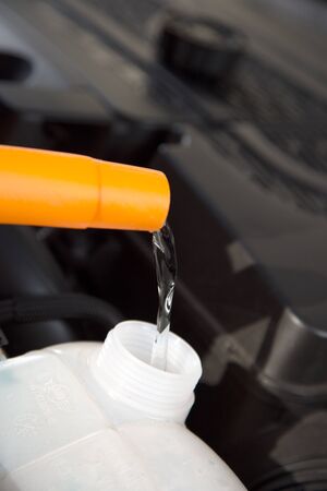 A close view from a can which is refilling the car water reservoir.の写真素材