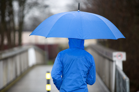 A walking people with umbrella in the rainの写真素材