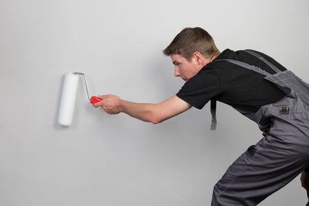 A ducked Painter in working dress isolated on a grey background.の写真素材