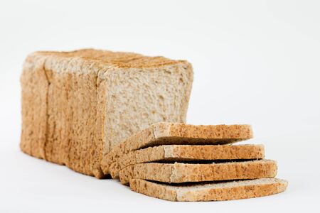 A frontview from a bread for toasting completely sliced and stacked isolated on a white background.の写真素材