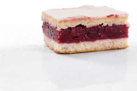 A fresh icing cake with cherry gelantine, isolated on a white backgroundの写真素材
