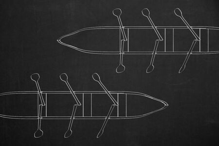 A top view from two rowboats drawed with white chalk on a dark chalkboard.の写真素材