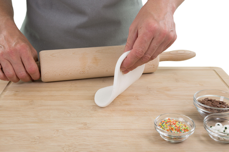 A woman cook rolling dough with rolling pin isolated on a white background.の写真素材