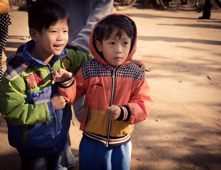 Lam Dong Province, Vietnam - January 24, 2015: The children's face before receiving gifts of ethnic minority children in the highlands. T?t c? gift for poor children come from a charity group.のeditorial素材
