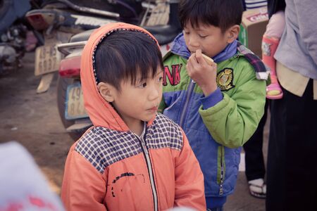 Lam Dong Province, Vietnam - January 24, 2015: The children's face before receiving gifts of ethnic minority children in the highlands. T?t c? gift for poor children come from a charity group.のeditorial素材