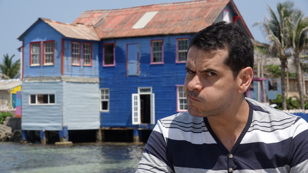 Man Making Funny Face And Old Houseの写真素材