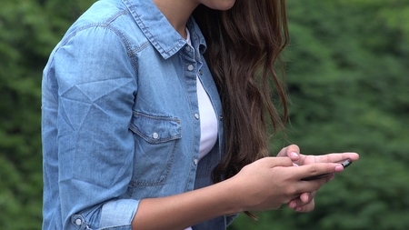 Girl Texting Or Using Smart Phoneの写真素材