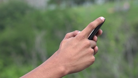 People Using A Smart Phone For Texting And Browsing Internetの写真素材