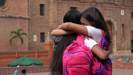 Female Teen Students Hugの写真素材