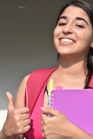 Young Girl Student With Thumbs Upの写真素材