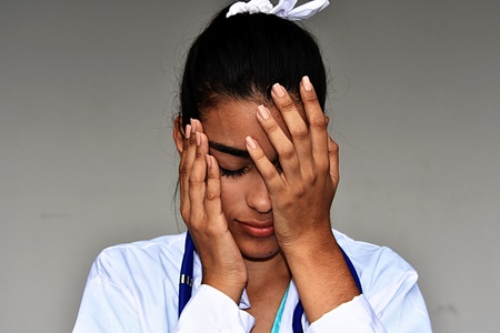 Depressed Young Hispanic Female Doctorの写真素材