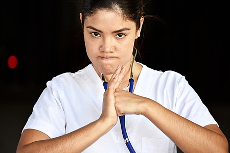 Upset Young Female Nurseの写真素材