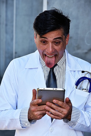 Goofy Handsome Male Medical Professional Wearing Lab Coatの写真素材