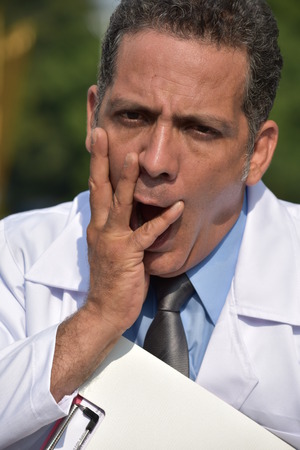 Stressed Male Doctor Wearing Lab Coatの写真素材