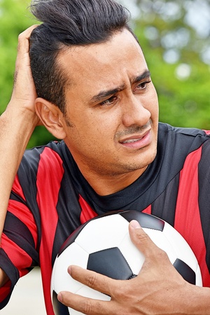 Confused Adult Male Soccer Playerの写真素材