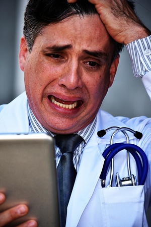 Stressed Male Medic Wearing Lab Coatの写真素材