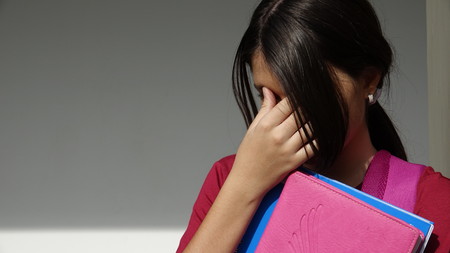 Unhappy Minority Girl Studentの写真素材