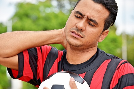 Sore Or Stressed Adult Male Soccer Playerの写真素材