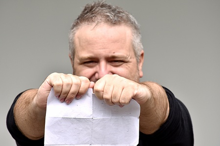 Angry Overweight Man Reading Documentsの写真素材