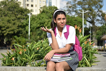 Confused Colombian Person With Books Sittingの写真素材