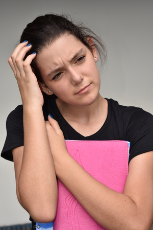 Confused Young Colombian Female Studentの写真素材