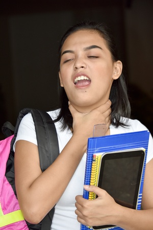 Choking Cute Girl Student With Notebooksの写真素材