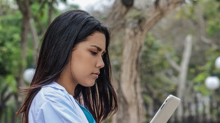 Cute Female Medic Reading Tabletの写真素材