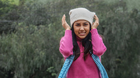 Teen Girl And Confusion Wearing Pink Sweaterの写真素材
