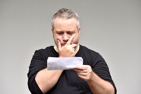 Overweight Man Reading Documentsの写真素材