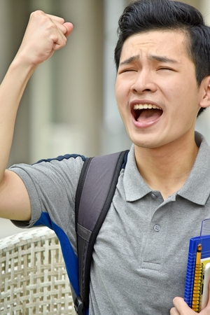 Angry Youthful Student With Booksの写真素材