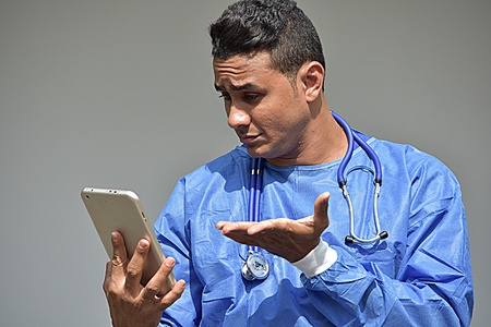 Male Doctor And Confusion With Tabletの写真素材