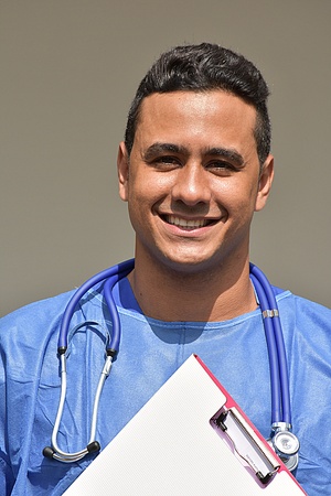 Smiling Intelligent Male Doctor With Clipboardの写真素材