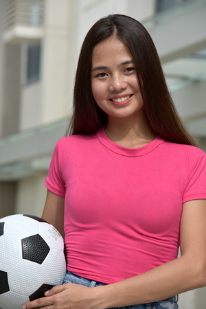 Asian Teen Athlete Female Soccer Player And Happinessの写真素材