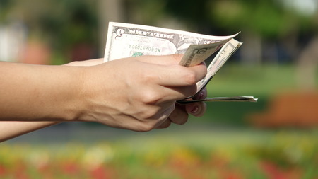 Hand Counting Dollar Billsの写真素材